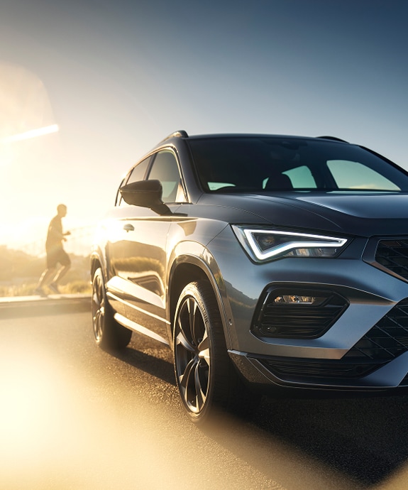 Person%20running%20behind%20Cupra%20car%20at%20sunrise