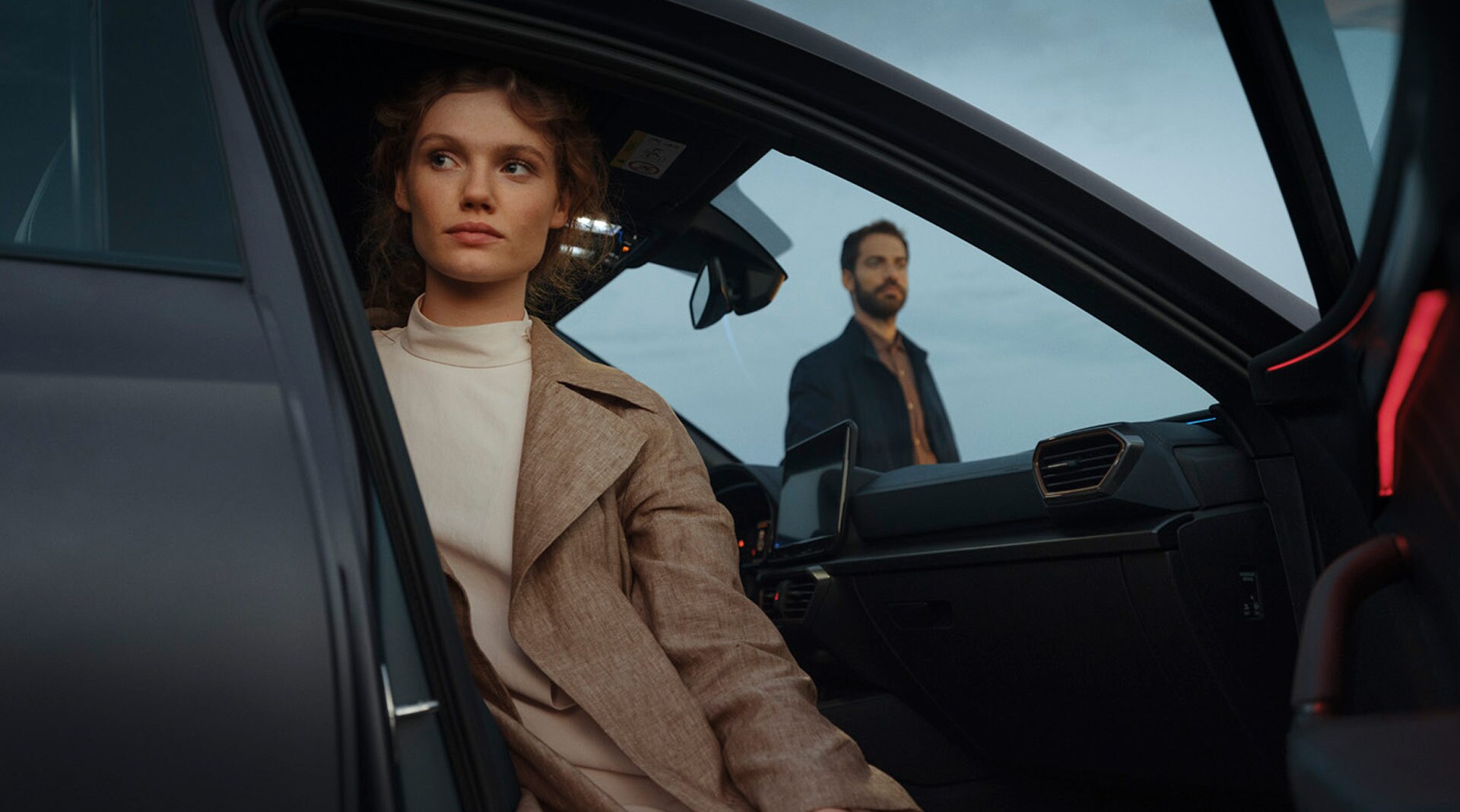 Woman sat in CUPRA with door open