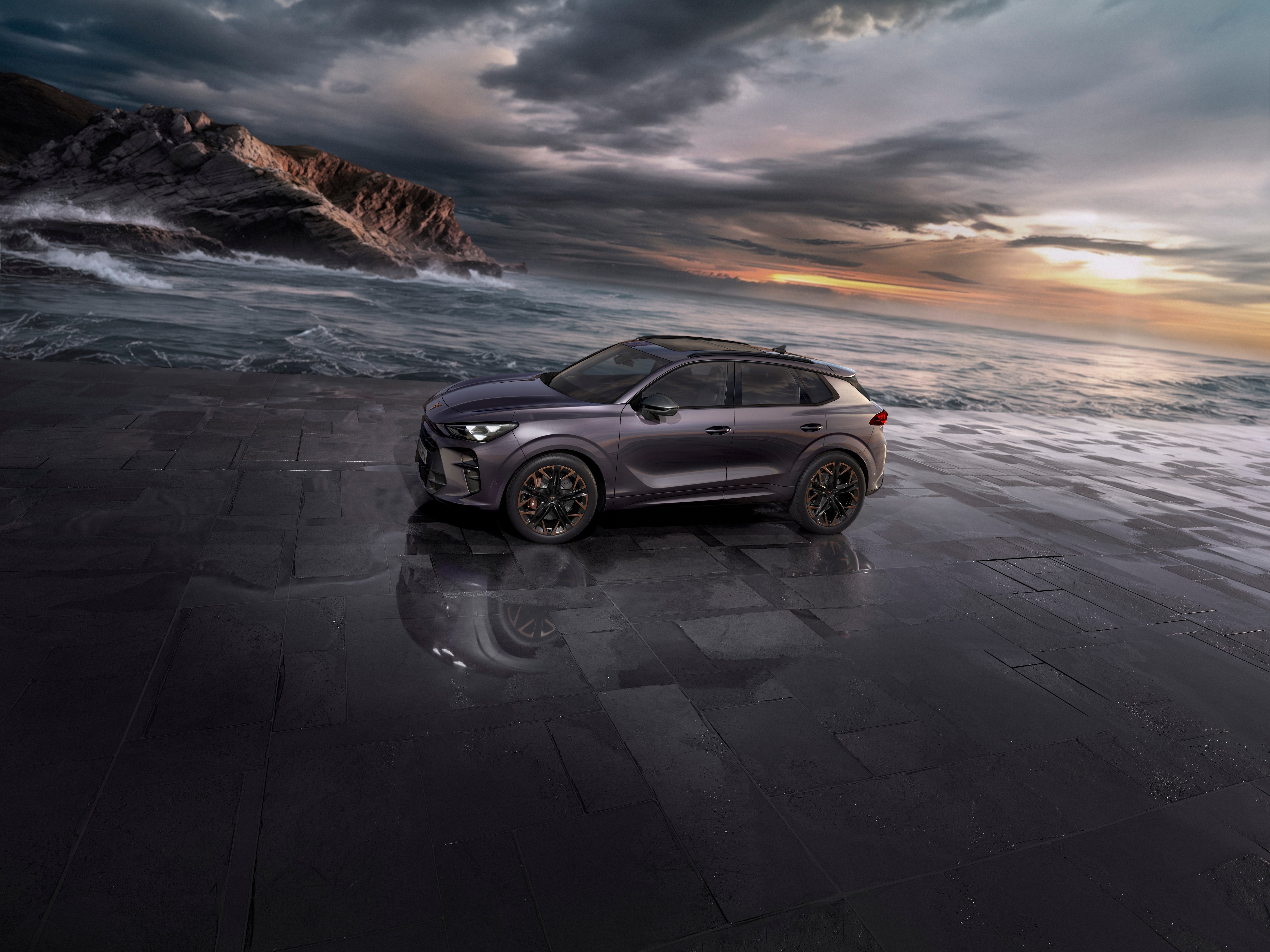 the new cupra terramar 2024 hybrid suv on a wet pavement by the sea, featuring sleek headlights, modern alloy wheels, and a shark-inspired front design.