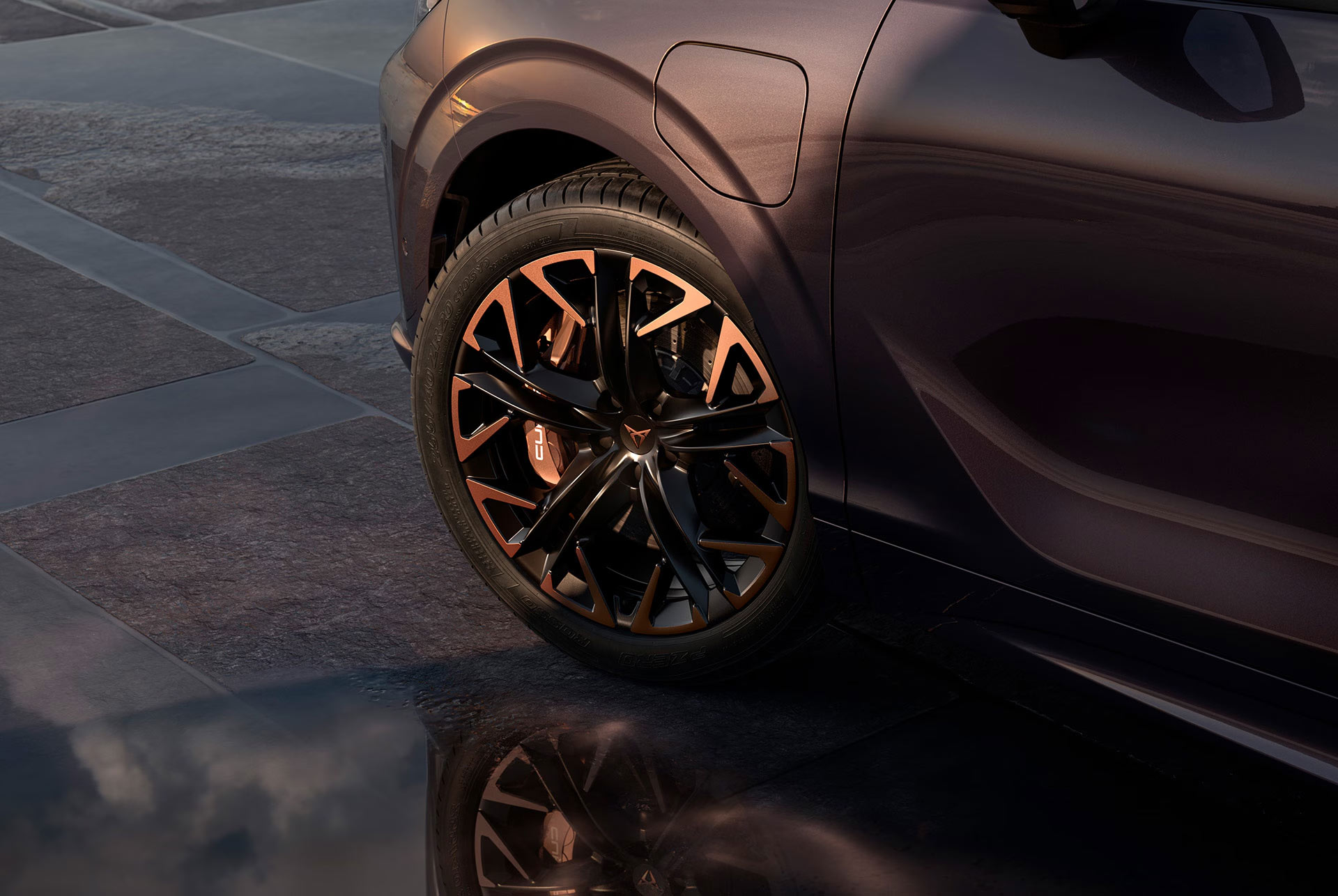 Front view of the CUPRA Ateca driving through water, showcasing its accentuated bonnet, full LED headlights, dark aluminium detailing and performance brakes with Brembo calipers.