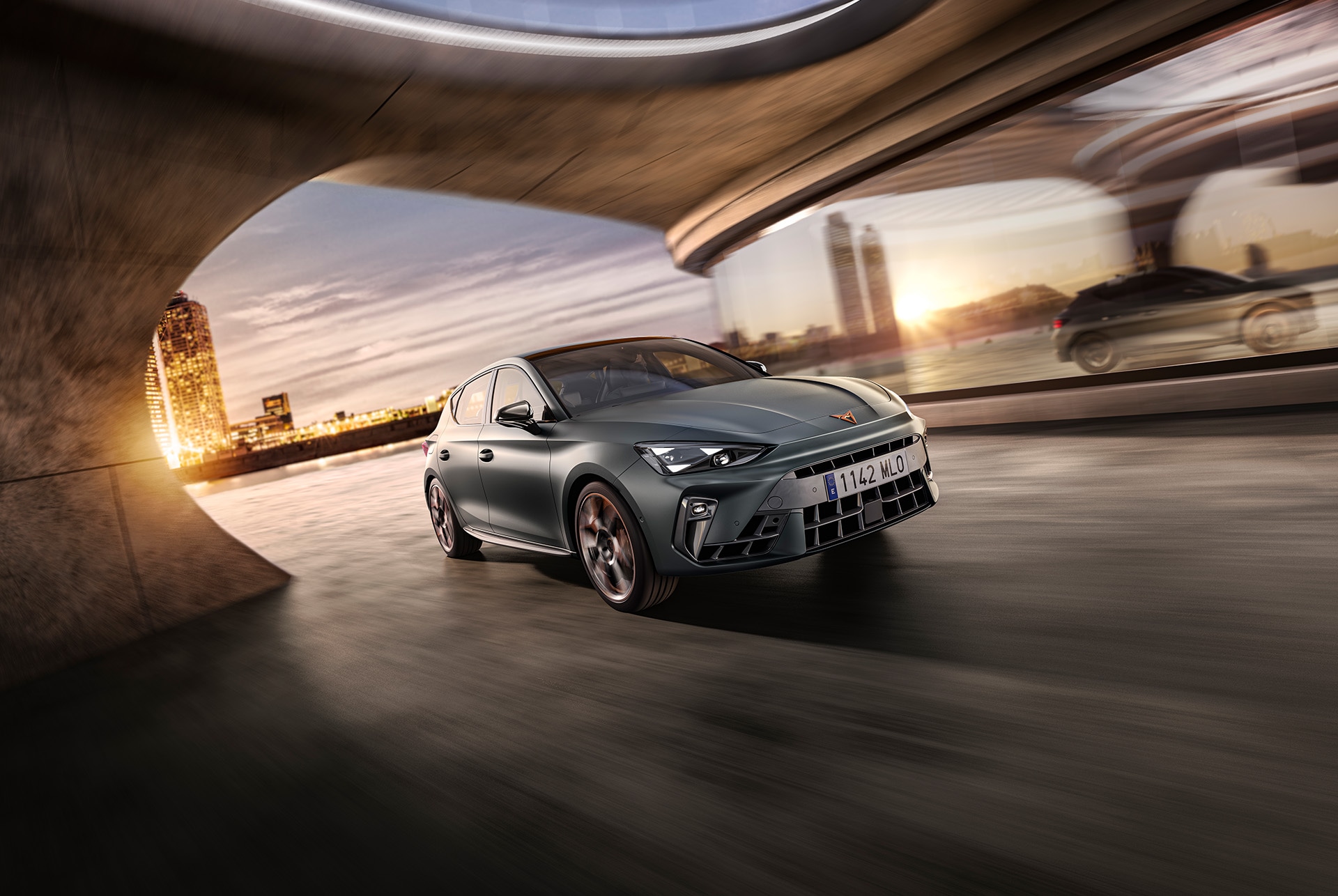three quarter front view of a new grey cupra leon 2024 in motion