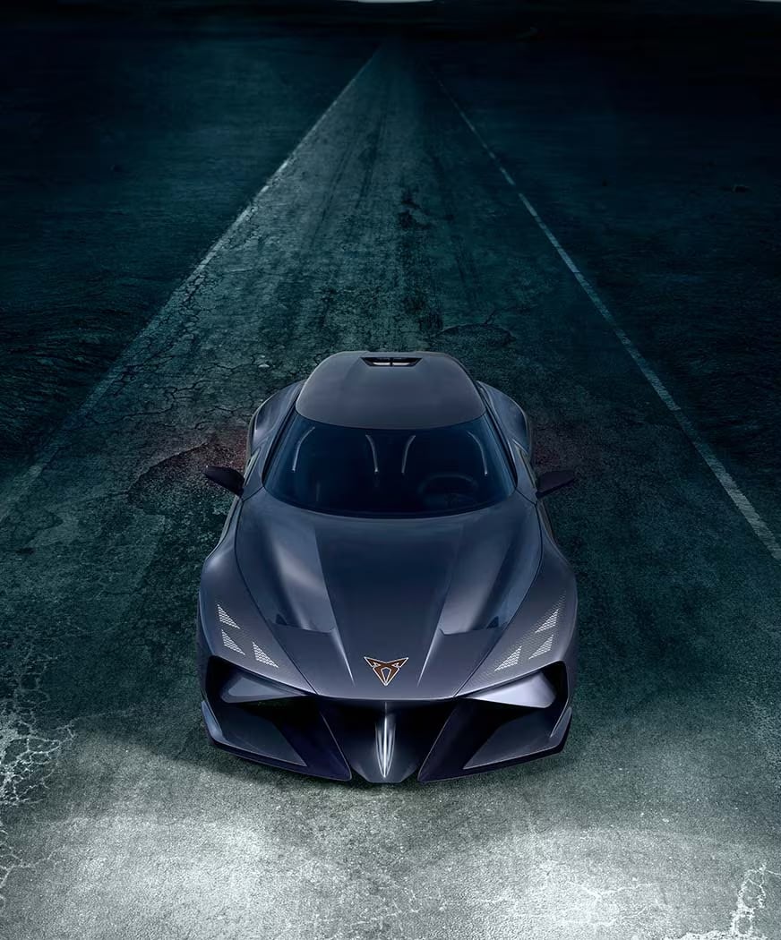 A minimalist image featuring a person wearing a dark hooded garment with subtle metallic details, against a black background.